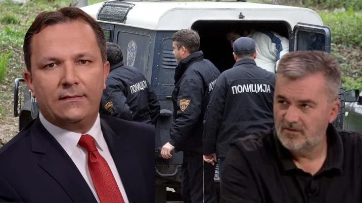 a man in a suit and tie standing in front of a van